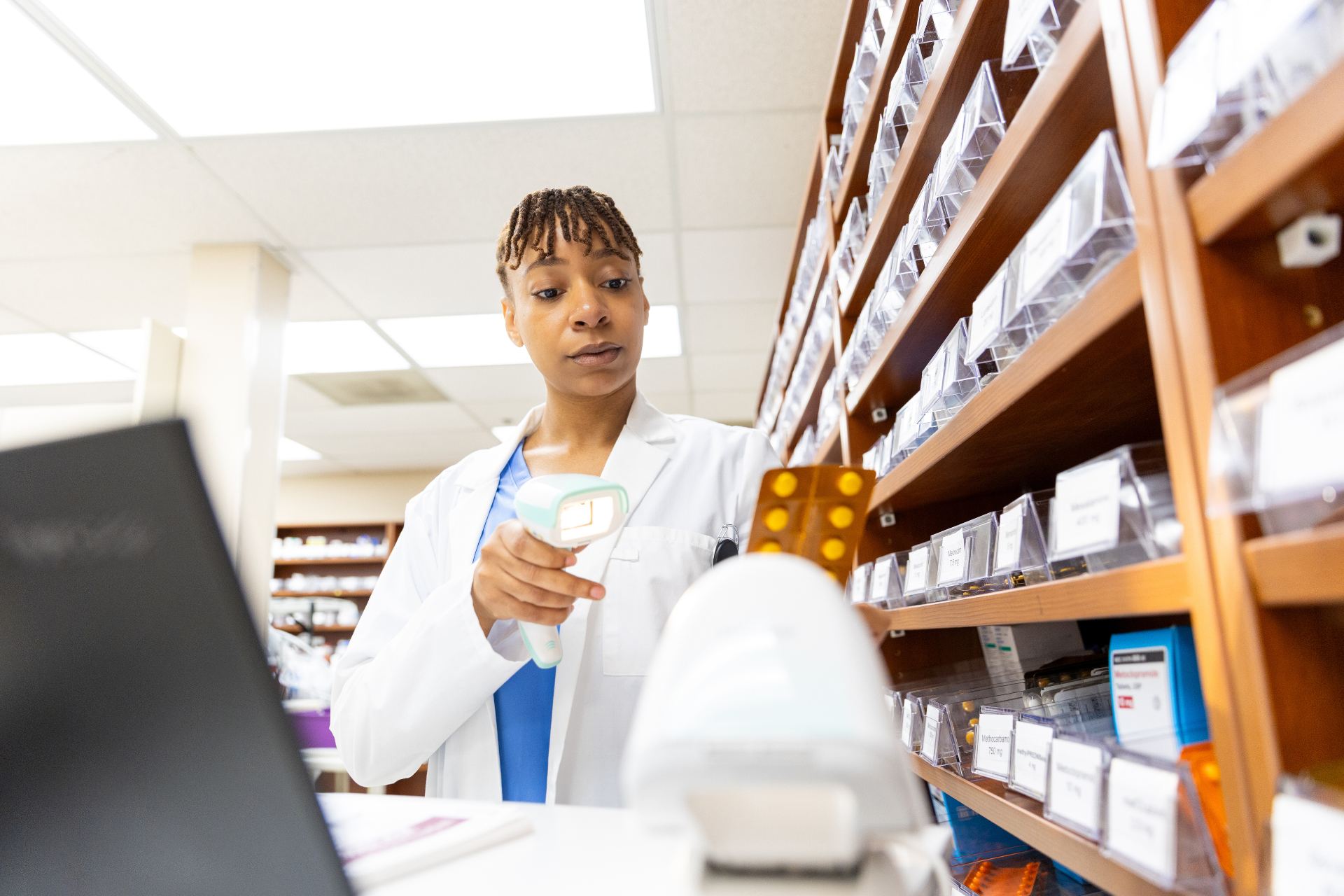 African pharmacist working at a hospital pharmacy counter